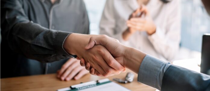 Business people shaking hands during a meeting.