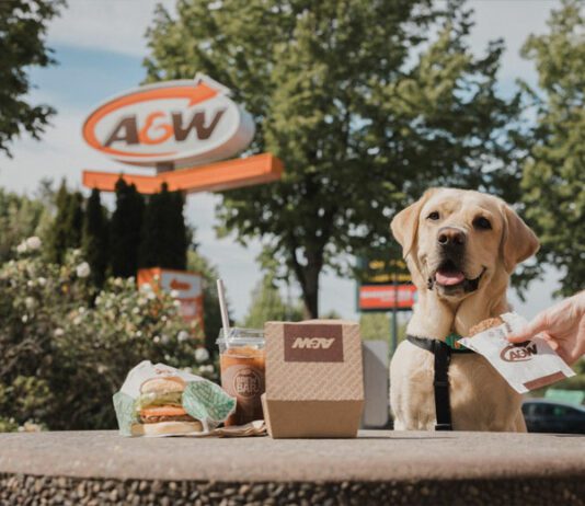 Dog standing beside a Burger outside A&W Restaurant